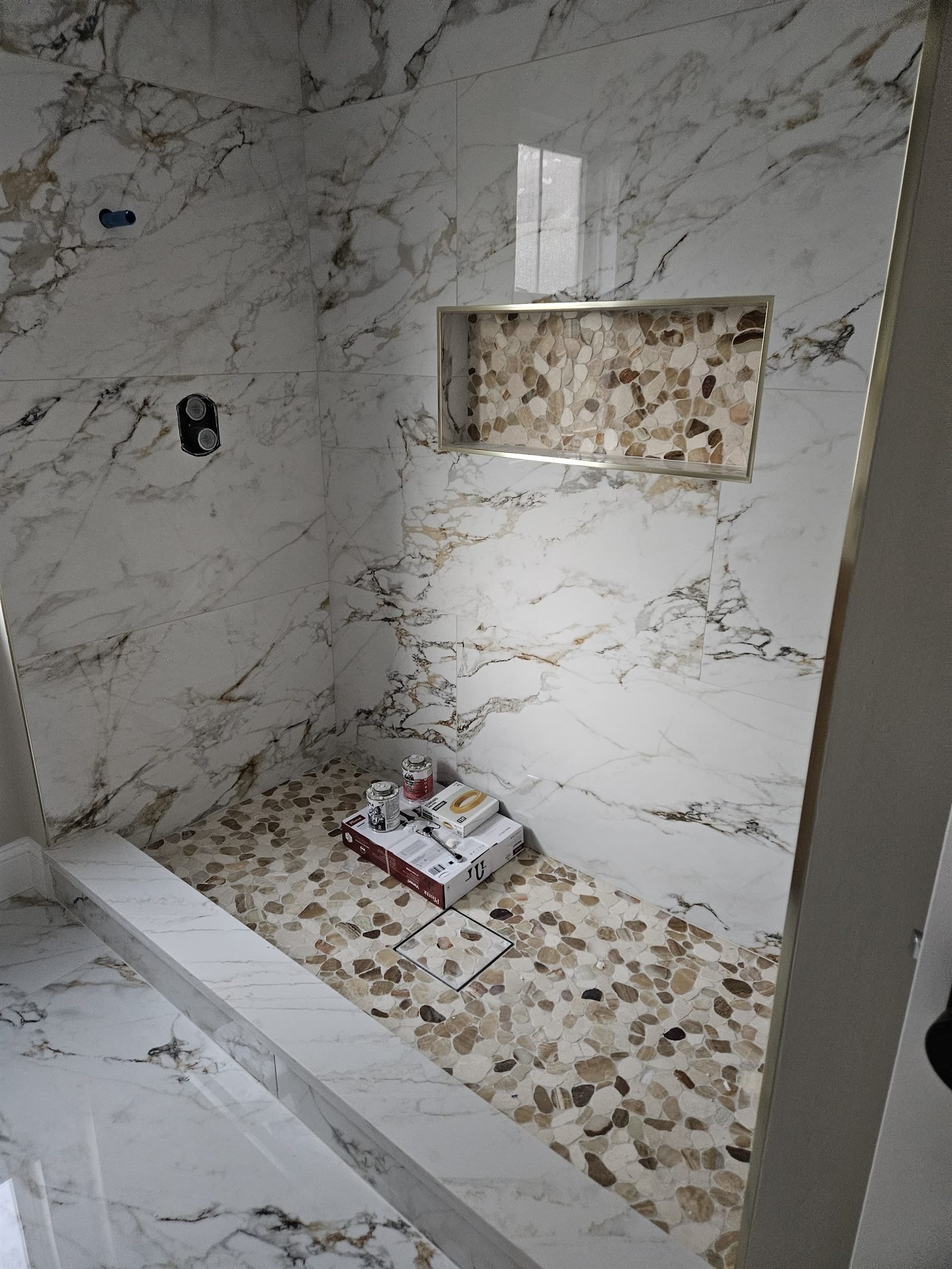 Renovated bathroom with stone-tile shower
