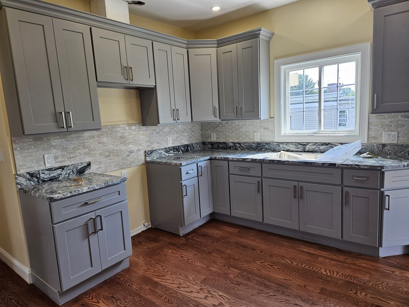 Kitchen sink with a gray subway-tile backsplash